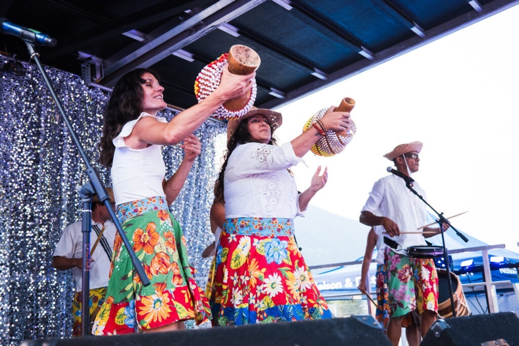 Amber Santos performs with musical ensemble Baque Zero Graus on the festival stage