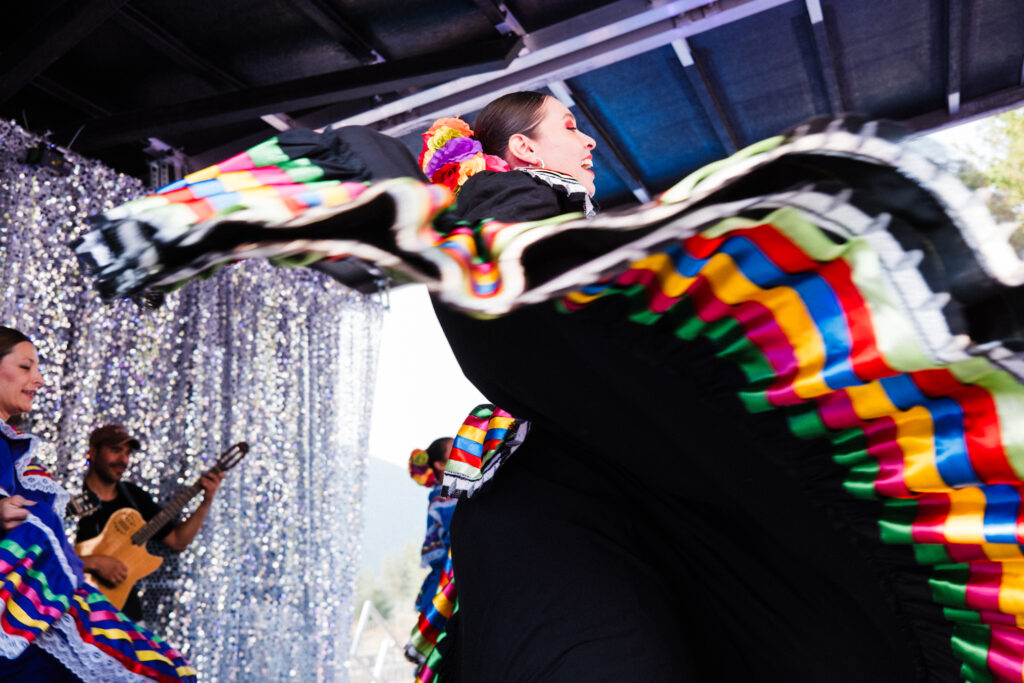 Tapatia Collective dancers wearing colourful layered skirts are in motion